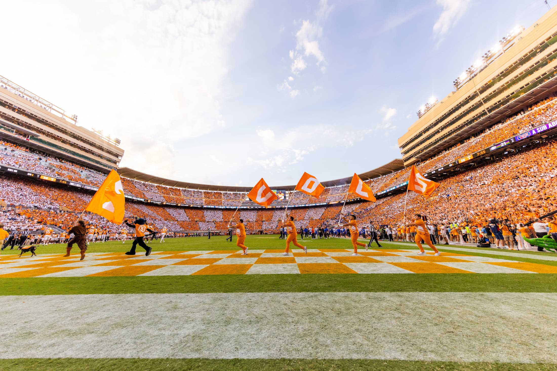 The UT Spirit Squad runs the VOLS lettes across the endzone after a score in front of checker boarded stadium during the Florida Gators and the Tennessee Volunteers football game at Neyland Stadium in Knoxville, TN